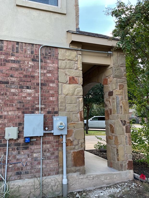 Exterior conduit run and surge protection at the meter on a Leander home