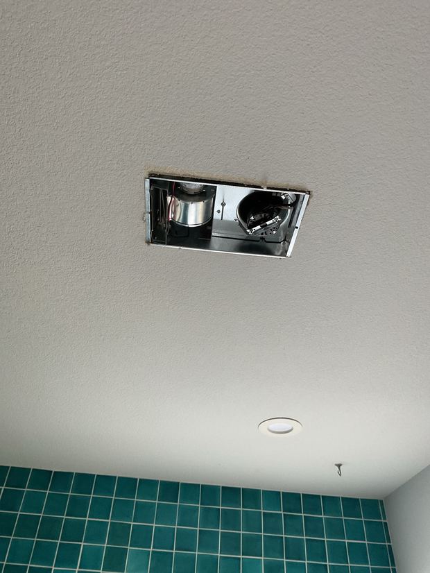 Bathroom exhaust fan being installed in a Pflugerville home