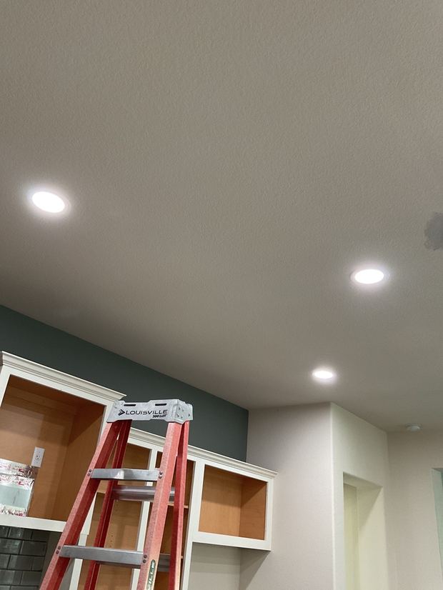 Recessed lighting installed over kitchen cabinets in a Round Rock home