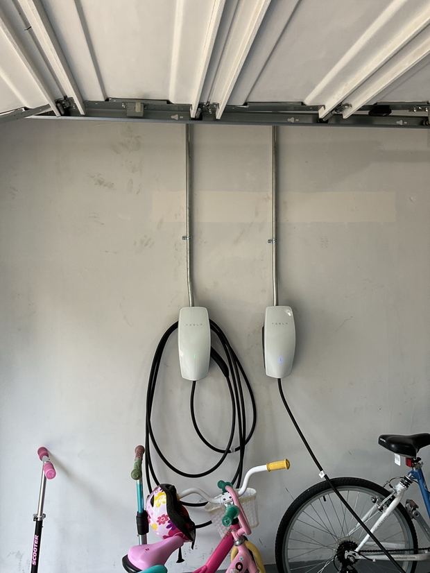 Two Tesla Wall Connector EV chargers installed in a Leander garage
